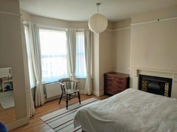 A bright and spacious master bedroom featuring ...