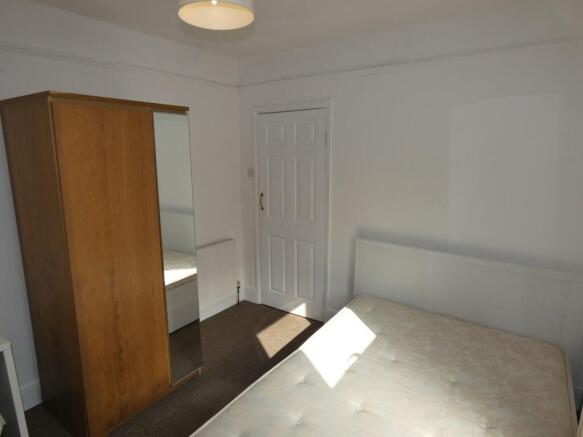 Bright double bedroom featuring a comfortable b...