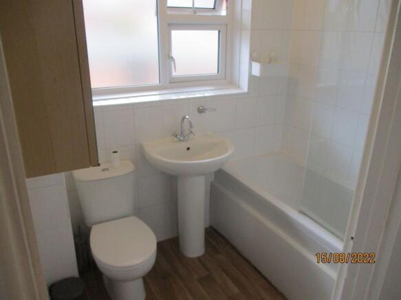 A bright and clean bathroom featuring a full-si...