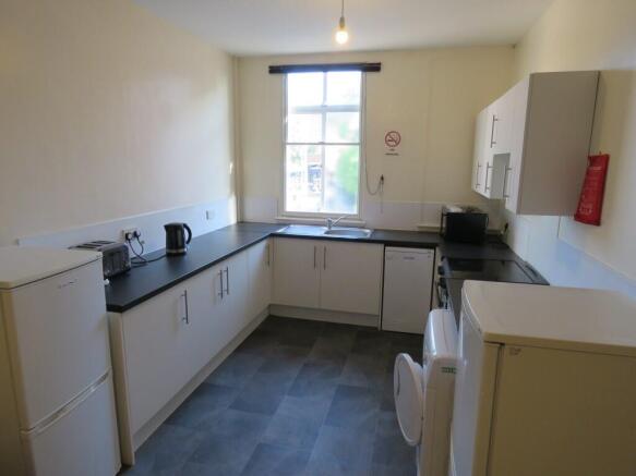 Bright and tidy kitchen featuring ample counter...