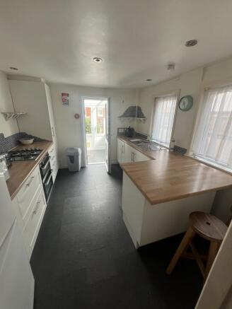 Bright kitchen featuring a well-maintained wood...