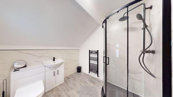 A modern and spacious bathroom suite featuring ...