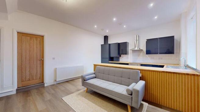 Bright and modern living room featuring a styli...