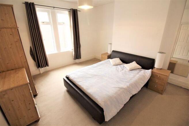 Bright and spacious master bedroom featuring a ...