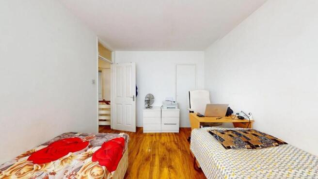 A bright and tidy double bedroom featuring two ...
