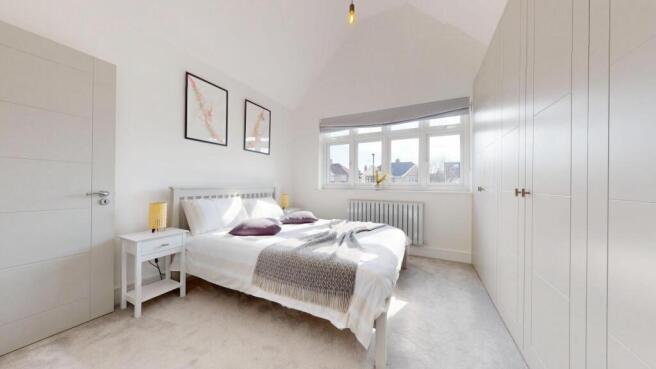 Bright and spacious master bedroom featuring a ...