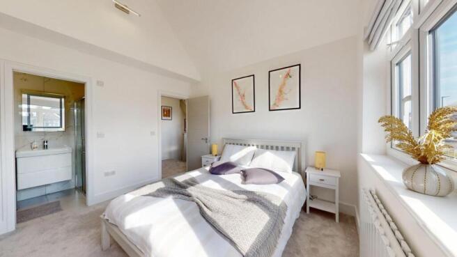 Bright and spacious master bedroom featuring a ...