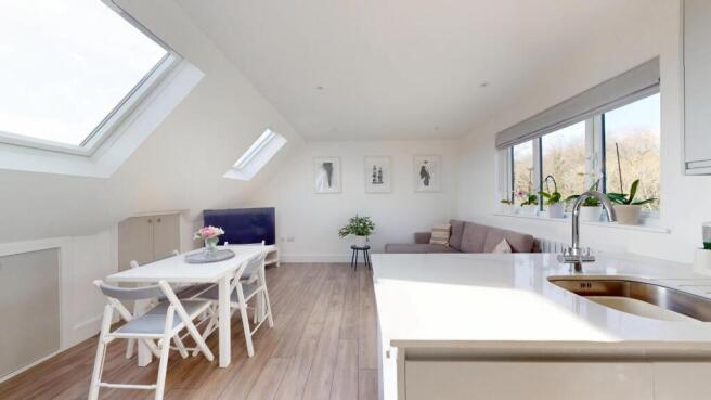 Bright and airy living room with modern white d...
