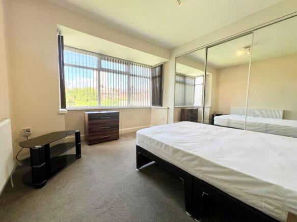 Bright and spacious master bedroom featuring a ...