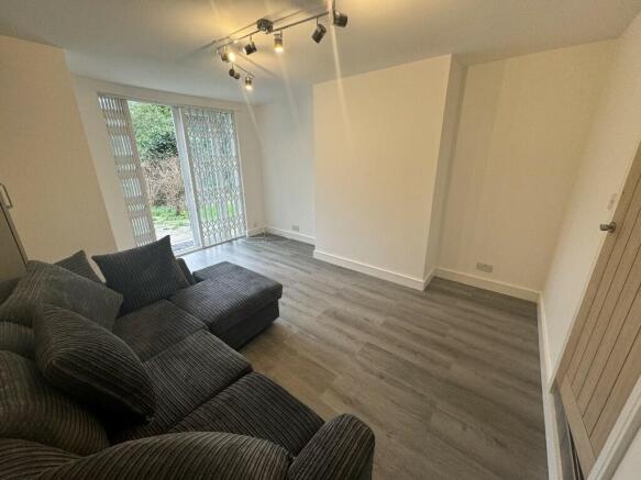 A cozy and bright living room with a comfortabl...