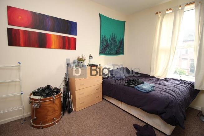 Cozy single bedroom with natural light streamin...