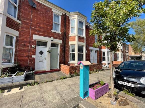 Bright and well-maintained terraced house front...