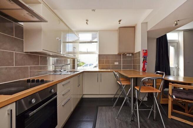 Bright and modern kitchen featuring ample count...