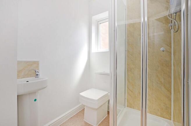 A bright, modern bathroom featuring a clear gla...