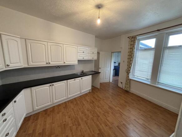 Bright and clean kitchen featuring a generous a...