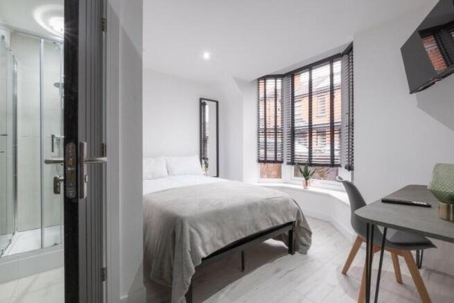 A bright and inviting double bedroom featuring ...