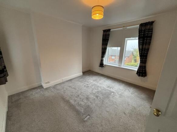 A bright and clean double bedroom featuring a l...