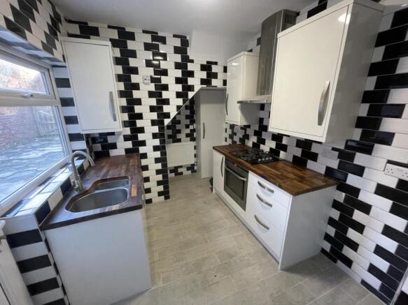 A modern and stylish kitchen with a unique blac...