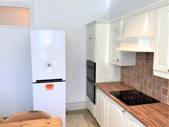 Bright and tidy kitchen featuring modern white ...