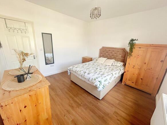 Bright and tidy double bedroom featuring a comf...