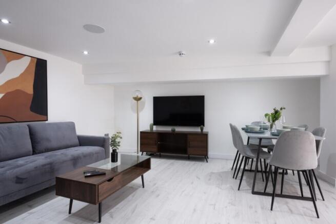 A modern living room featuring a stylish grey c...
