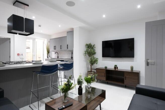 This stylish living room features a modern desi...