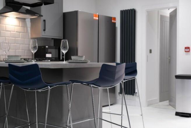 This modern kitchen features sleek cabinetry, a...