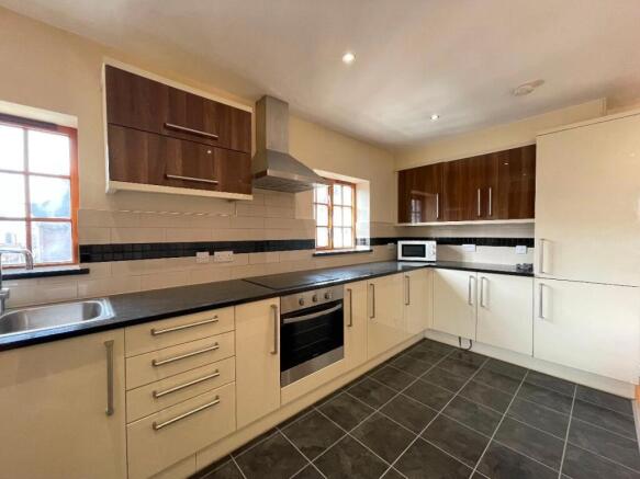 Modern kitchen featuring ample cabinetry, integ...