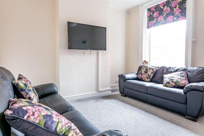 A cozy living room featuring two comfortable bl...