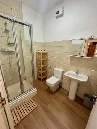 A clean and modern bathroom featuring a glass-e...