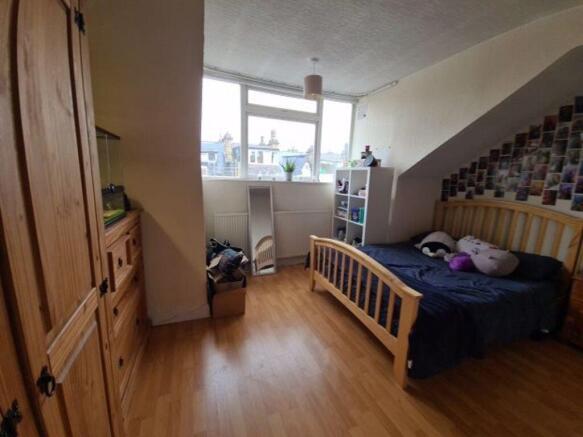 Bright double bedroom featuring a large window ...