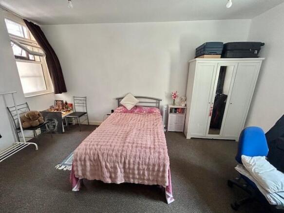 Cozy single bedroom featuring a comfortable bed...