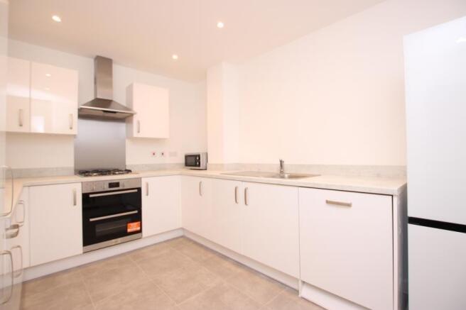Bright modern kitchen with white gloss cabinets...