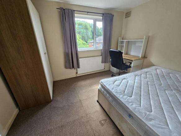A bright, well-maintained bedroom featuring a c...