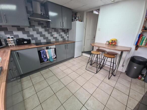 A modern kitchen featuring sleek grey cabinetry...