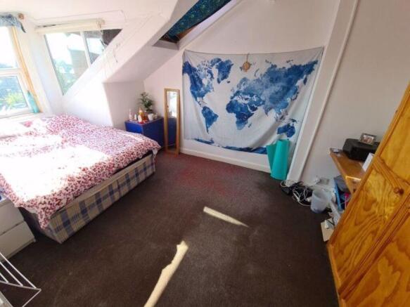 A bright and inviting master bedroom featuring ...