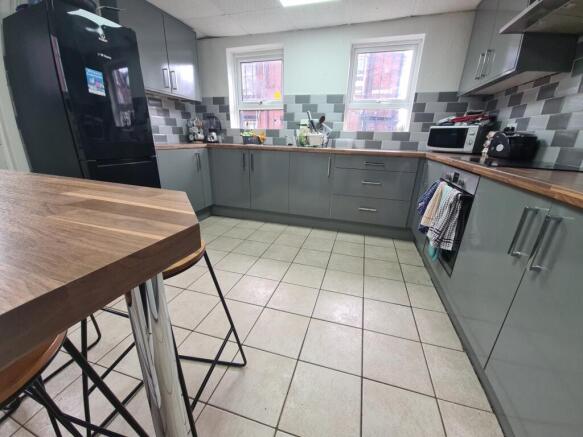 A modern kitchen featuring sleek cabinetry with...