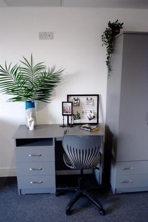 A modern communal workspace featuring a stylish...
