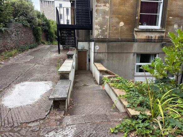 Stone path and steps leading down to a lower-le...