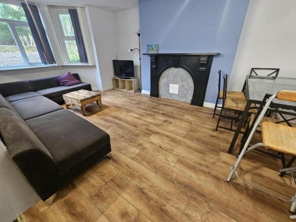 A spacious and well-maintained living room feat...