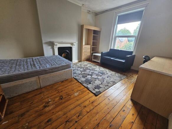 A bright and cozy bedroom featuring a single be...