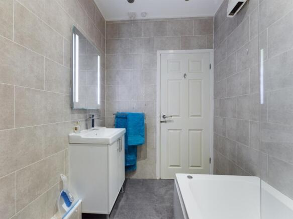 A spacious and modern bathroom featuring a styl...