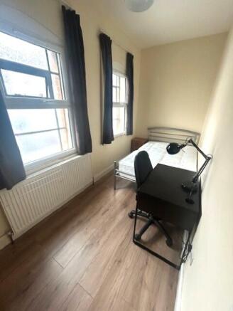 A neat and bright single bedroom featuring two ...