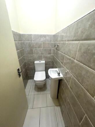 A clean and modern small toilet area featuring ...