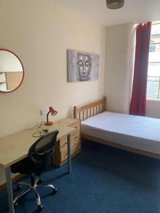 A bright and inviting double bedroom with ample...