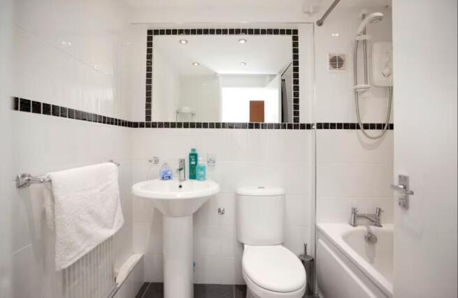 A modern and clean bathroom featuring a bath an...