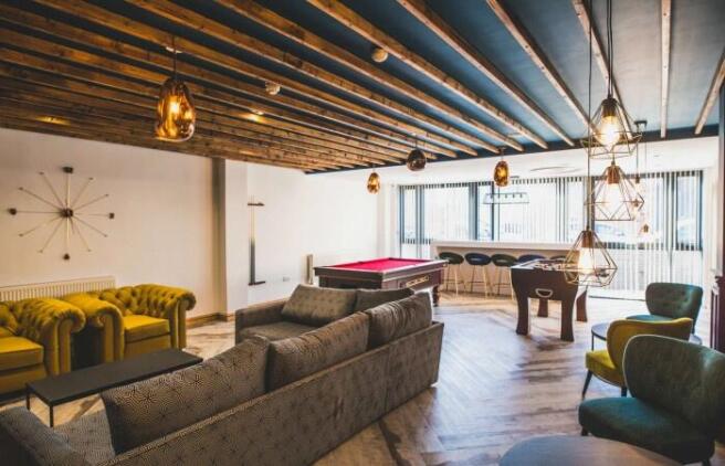 A stylish communal lounge featuring a spacious ...