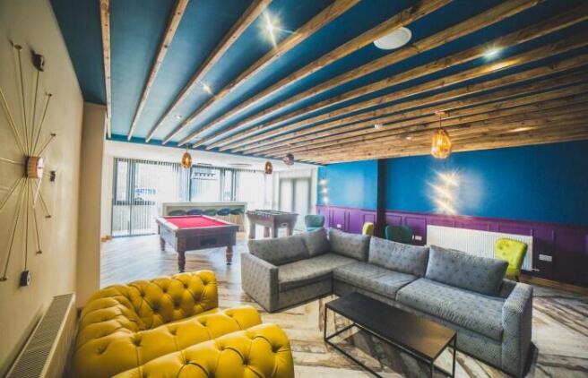 A vibrant communal lounge featuring a spacious ...