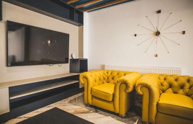 A stylish living room featuring two vibrant yel...