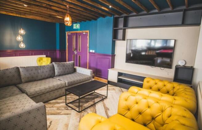 A stylish and contemporary living room featurin...